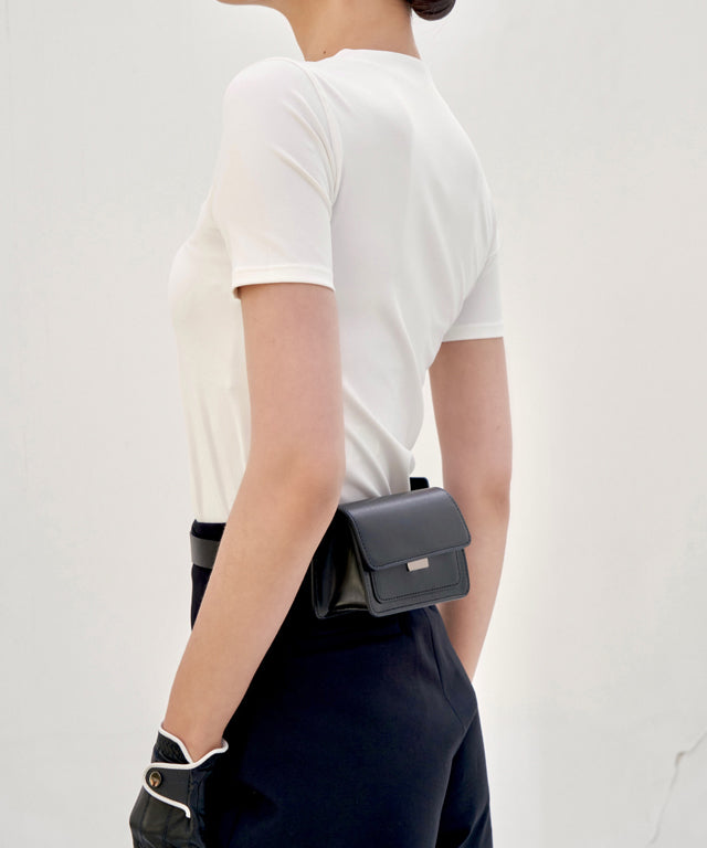 Anell Golf Cotton Wrap Skirt Pants in Black, showcasing a stylish semi-A-line design with a diagonal slit for a flattering fit.