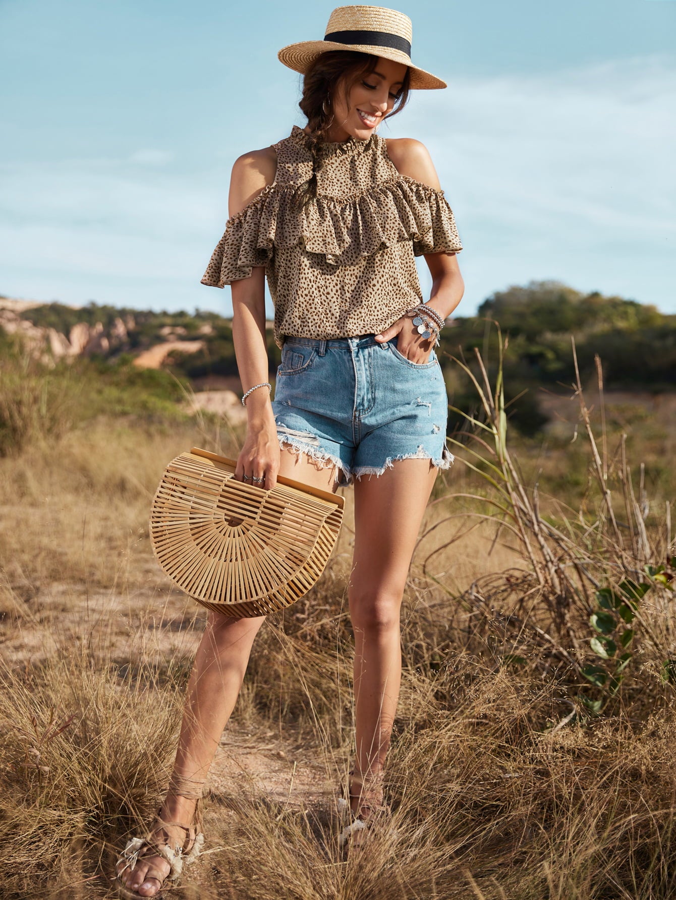 A stylish animal print cold-shoulder ruffled blouse displayed on a mannequin, showcasing its trendy design and casual elegance.