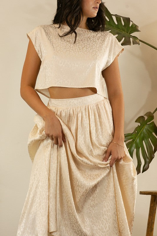 A stylish animal print cropped skirt set featuring a trendy top and flowing skirt, perfect for parties and casual outings.