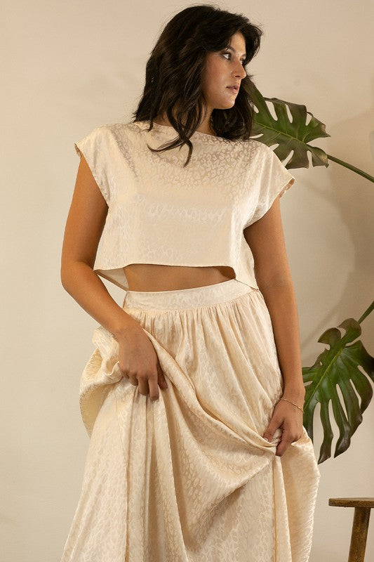 A stylish animal print cropped skirt set featuring a trendy top and flowing skirt, perfect for parties and casual outings.