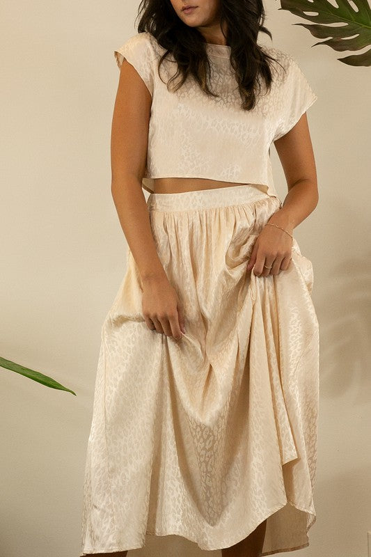 A stylish animal print cropped skirt set featuring a trendy top and flowing skirt, perfect for parties and casual outings.