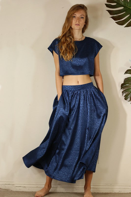 A stylish animal print cropped skirt set featuring a trendy top and flowing skirt, perfect for parties and casual outings.