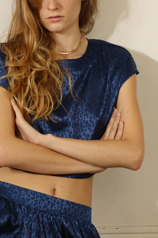 A stylish animal print cropped skirt set featuring a trendy top and flowing skirt, perfect for parties and casual outings.