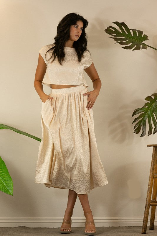 A stylish animal print cropped skirt set featuring a trendy top and flowing skirt, perfect for parties and casual outings.