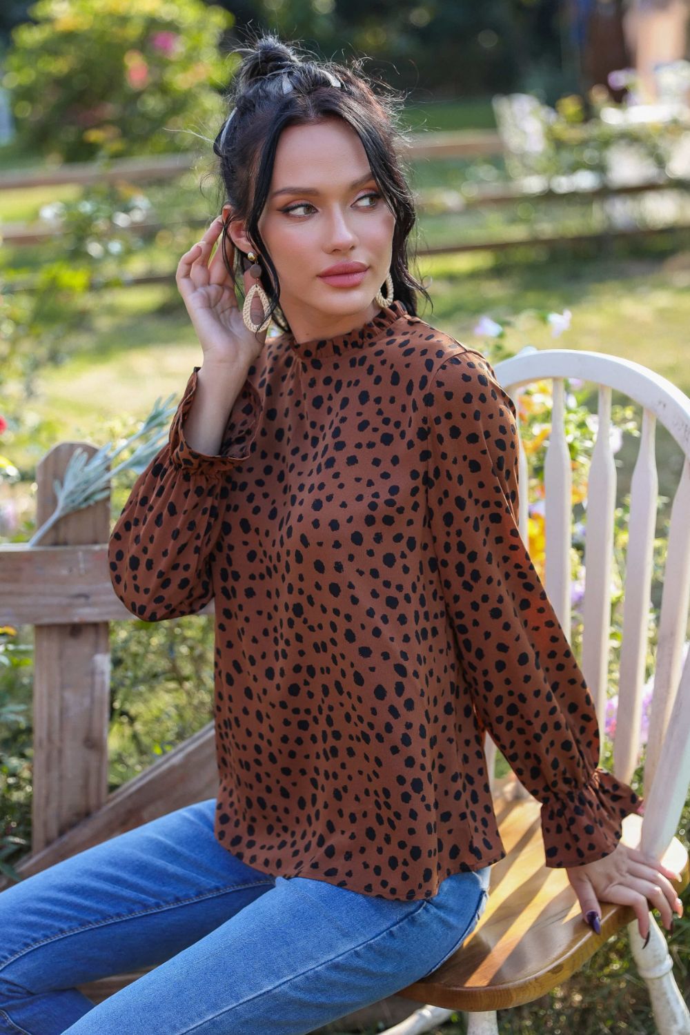 A stylish animal print blouse featuring a frill neck and flounce sleeves, perfect for casual wear.