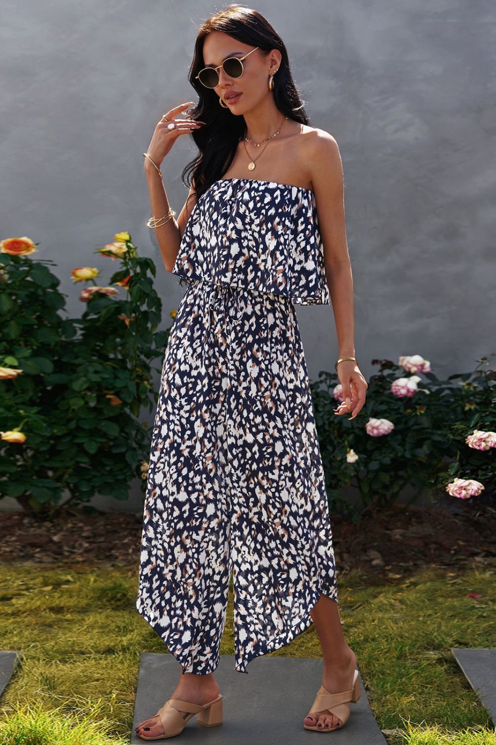 A stylish animal print strapless layered jumpsuit displayed on a mannequin, showcasing its elegant design and vibrant colors.