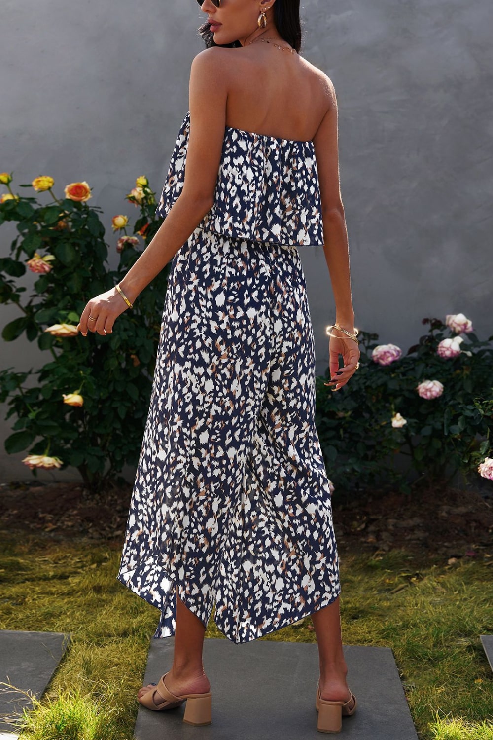 A stylish animal print strapless layered jumpsuit displayed on a mannequin, showcasing its elegant design and vibrant colors.