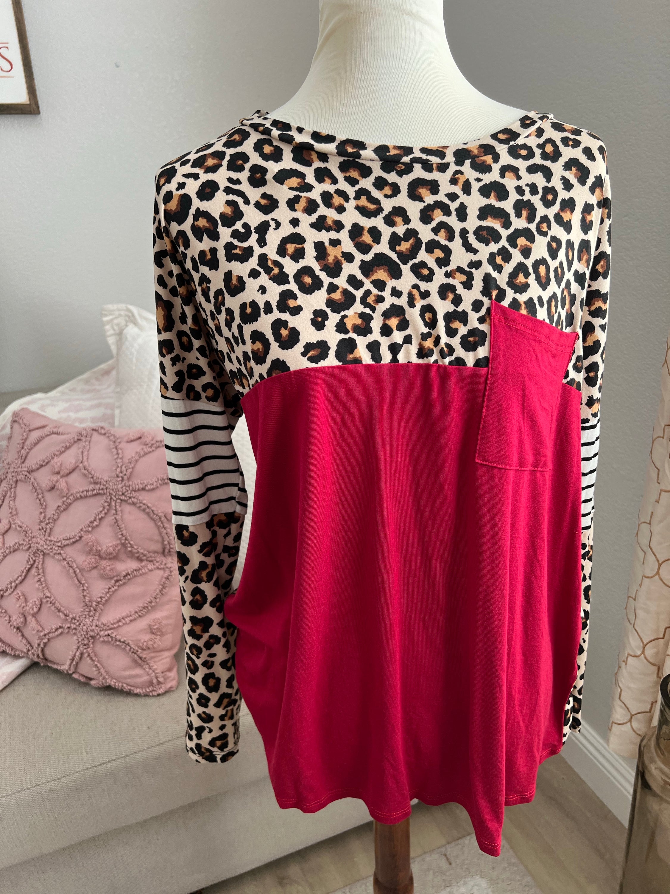 A stylish medium-sized animal print tunic featuring a loose fit, perfect for casual or dressy occasions.