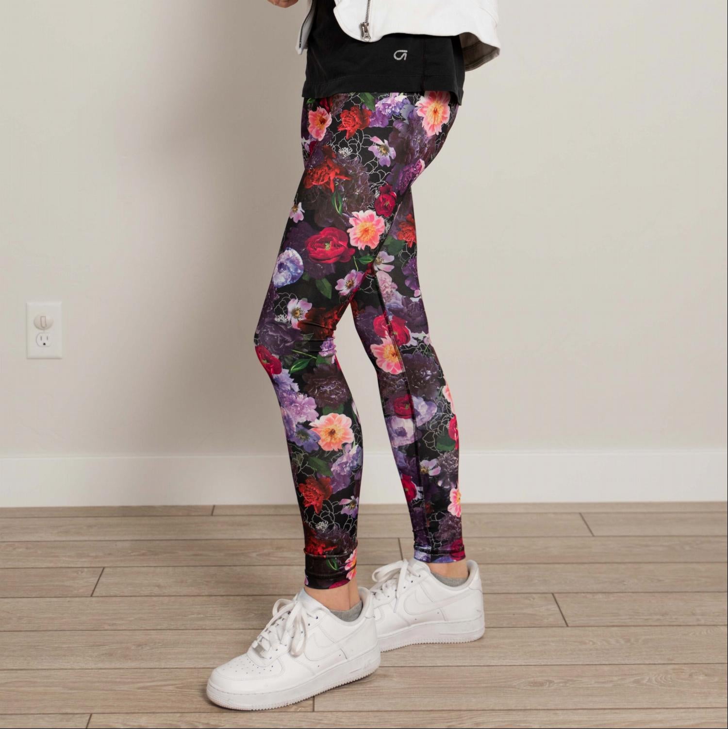Ankle length floral high waist active pants displayed on a mannequin, showcasing vibrant floral print and flexible fabric.