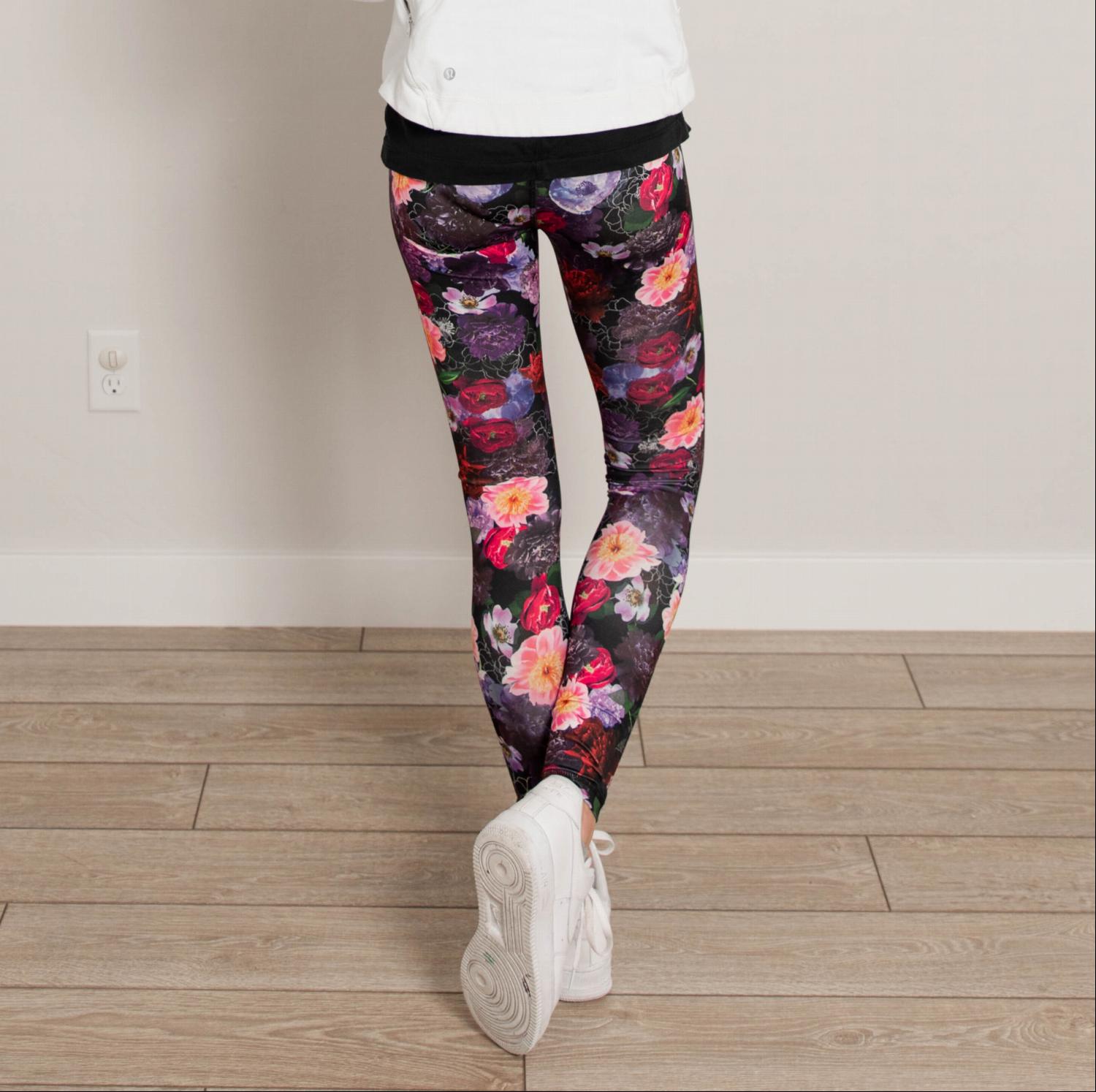 Ankle length floral high waist active pants displayed on a mannequin, showcasing vibrant floral print and flexible fabric.