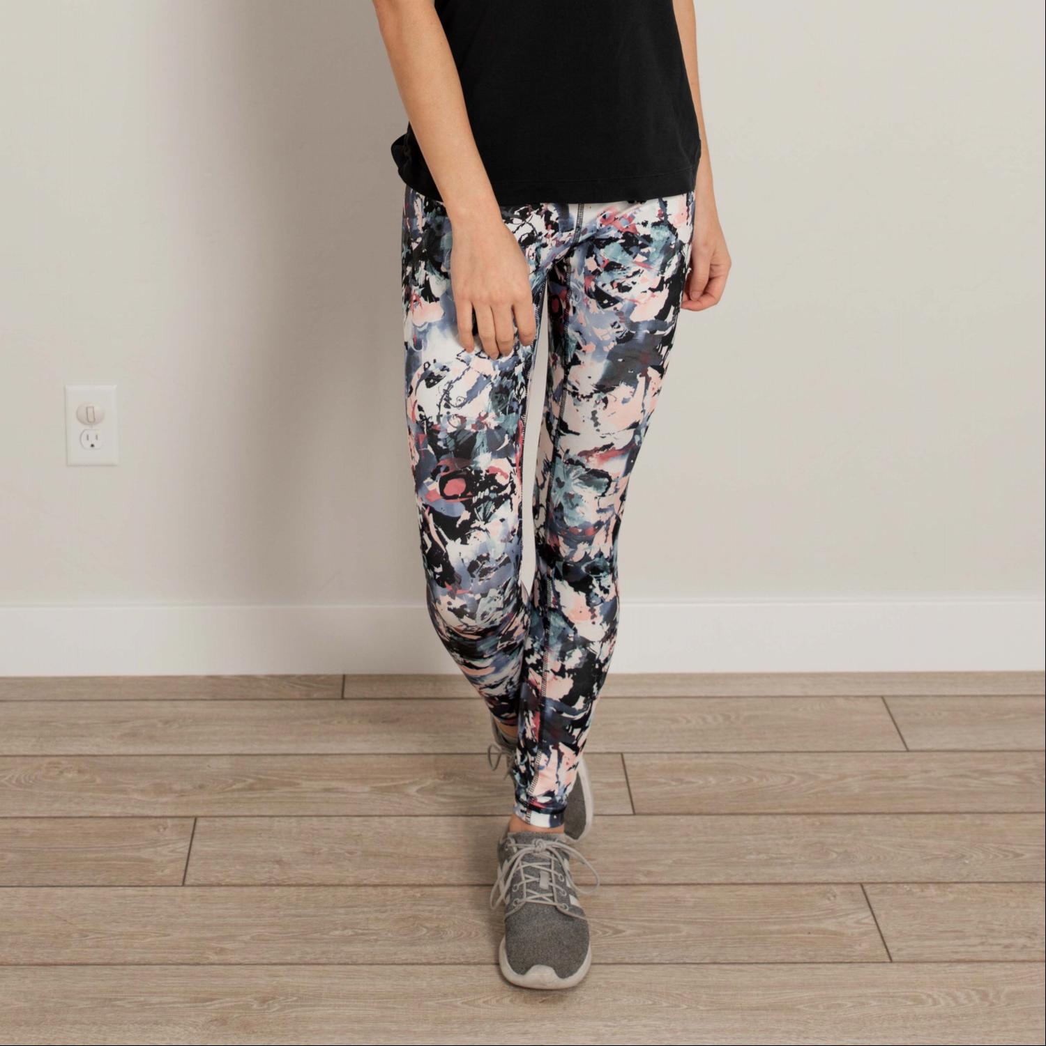 Ankle length floral high waist active pants displayed on a mannequin, showcasing vibrant floral print and flexible fabric.