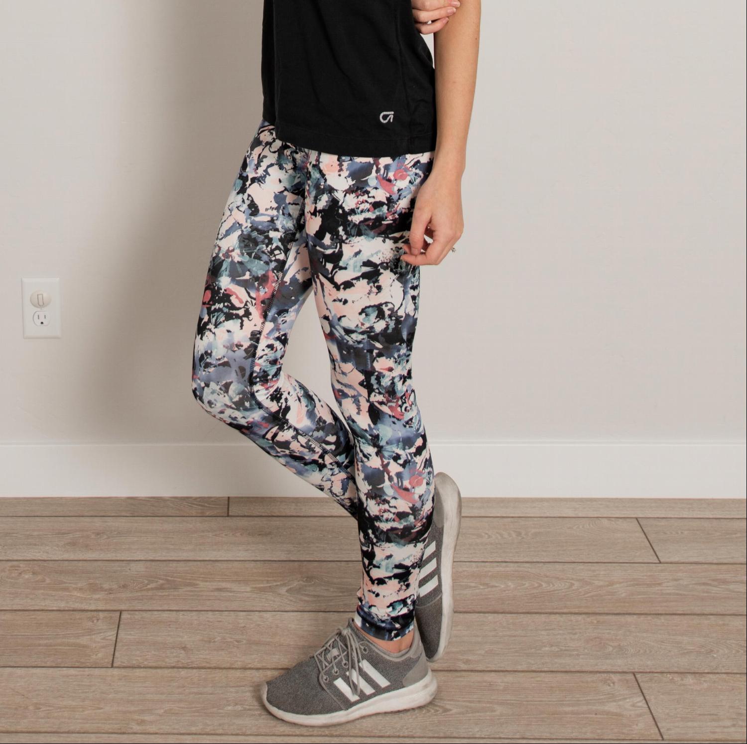 Ankle length floral high waist active pants displayed on a mannequin, showcasing vibrant floral print and flexible fabric.