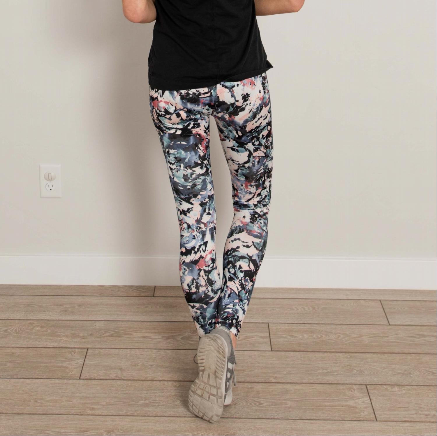 Ankle length floral high waist active pants displayed on a mannequin, showcasing vibrant floral print and flexible fabric.