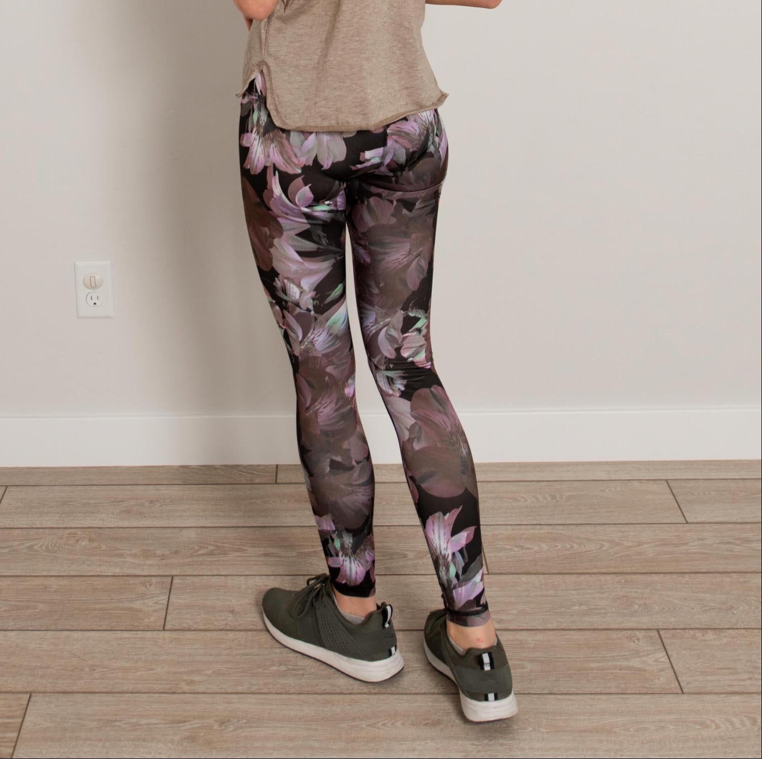 Ankle length floral high waist active pants displayed on a mannequin, showcasing vibrant floral print and flexible fabric.