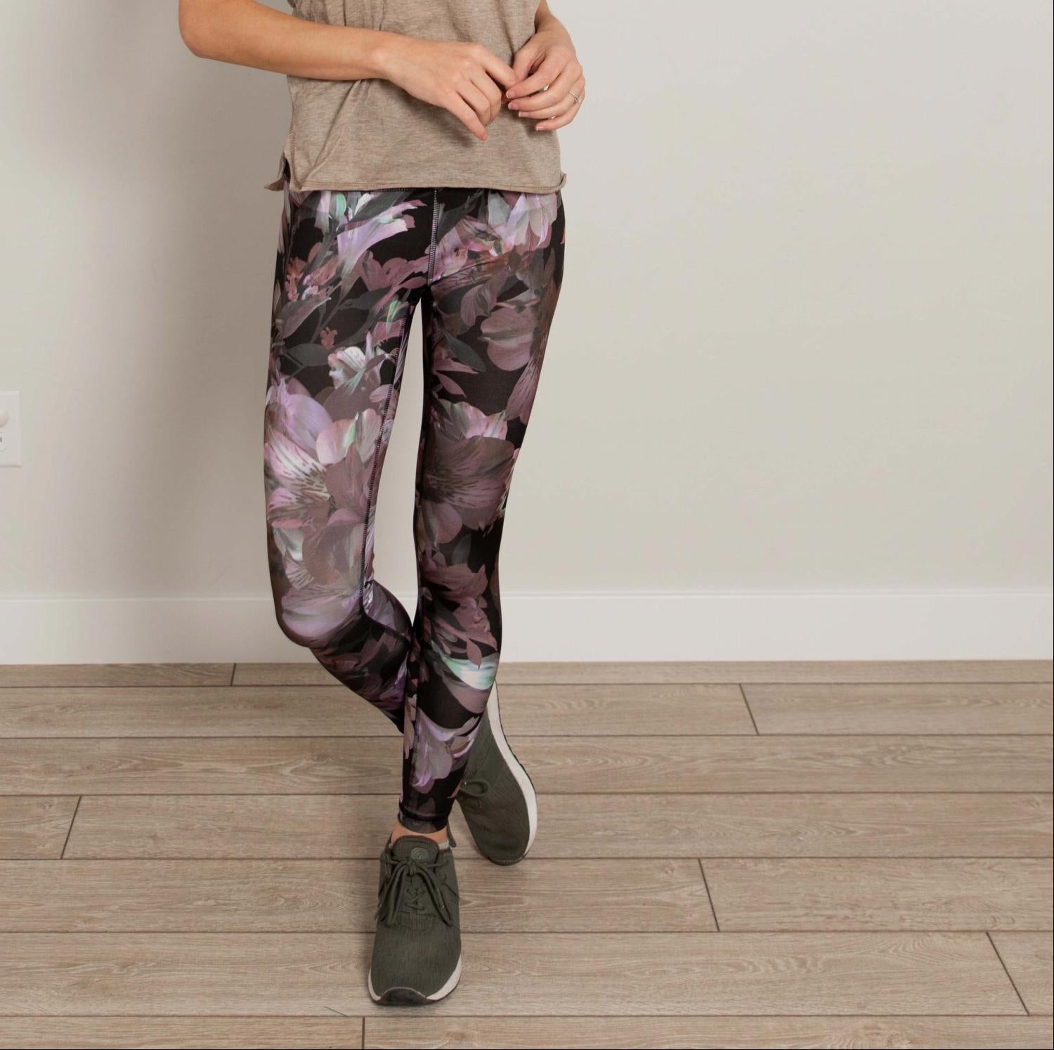 Ankle length floral high waist active pants displayed on a mannequin, showcasing vibrant floral print and flexible fabric.