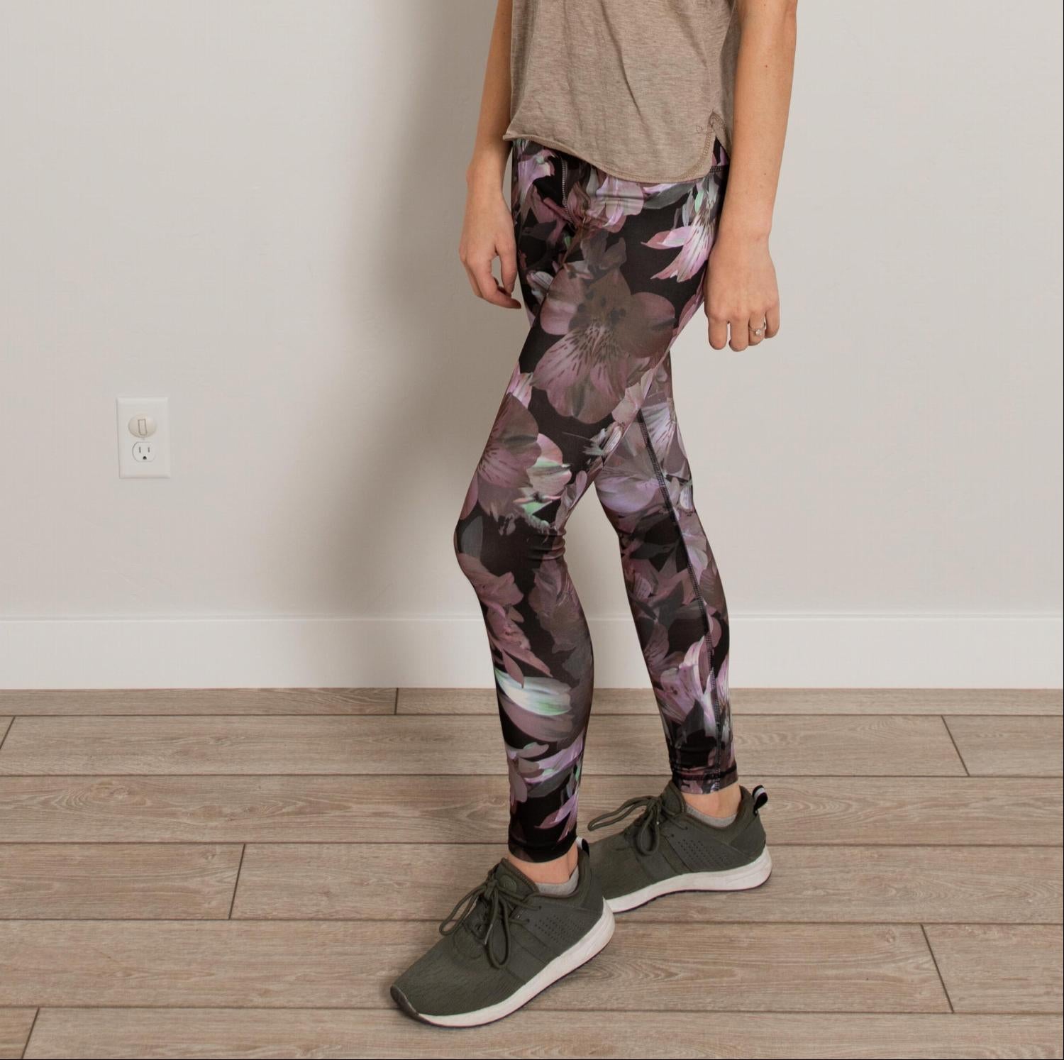 Ankle length floral high waist active pants displayed on a mannequin, showcasing vibrant floral print and flexible fabric.