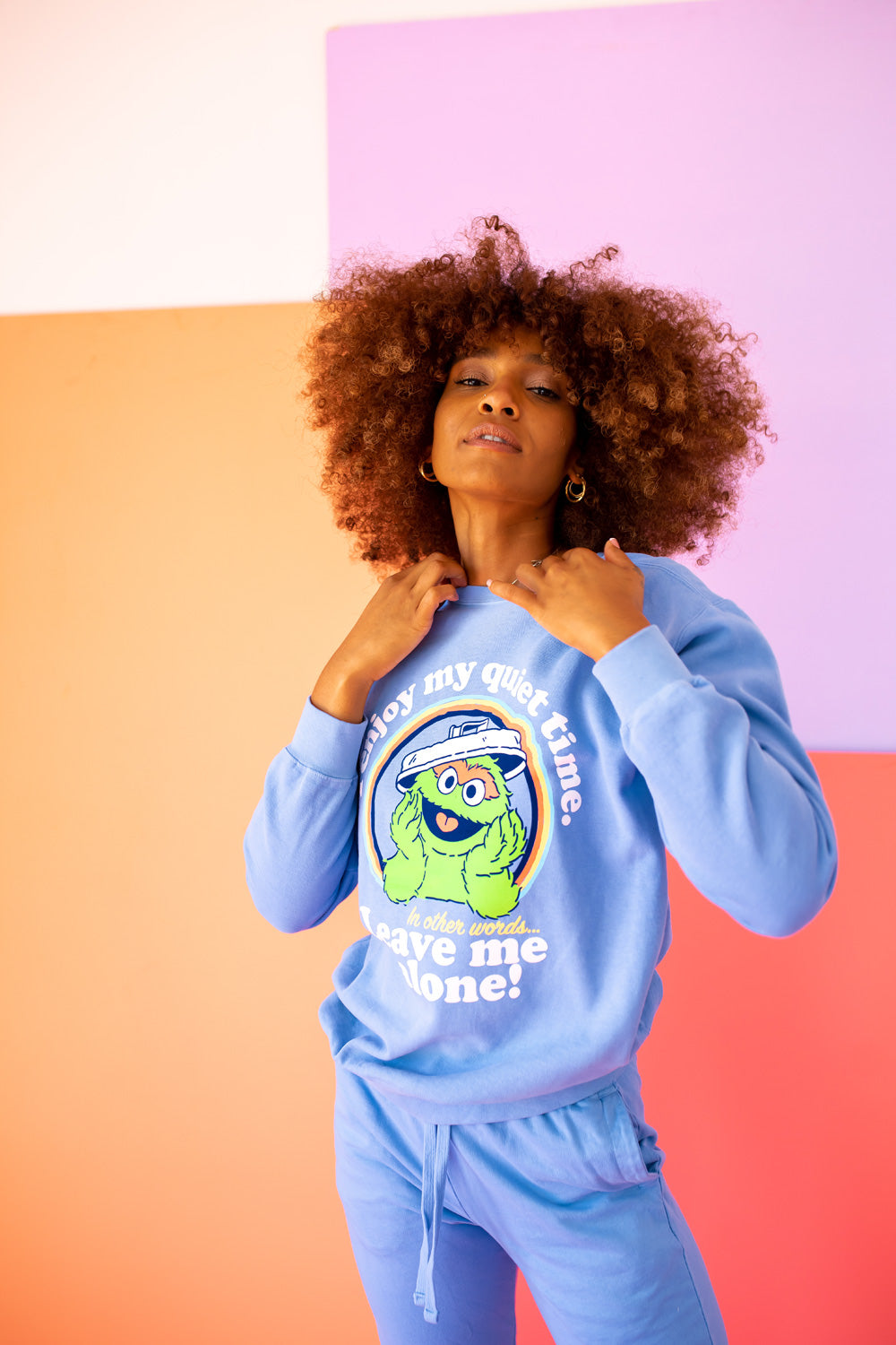 A vibrant blue sweatshirt featuring Oscar The Grouch, showcasing a playful design perfect for casual wear.