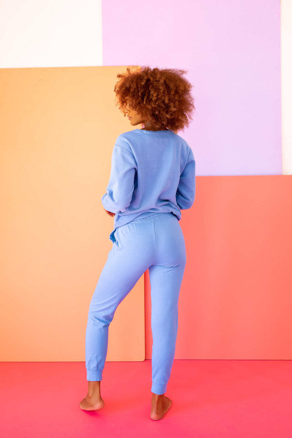 A vibrant blue sweatshirt featuring Oscar The Grouch, showcasing a playful design perfect for casual wear.