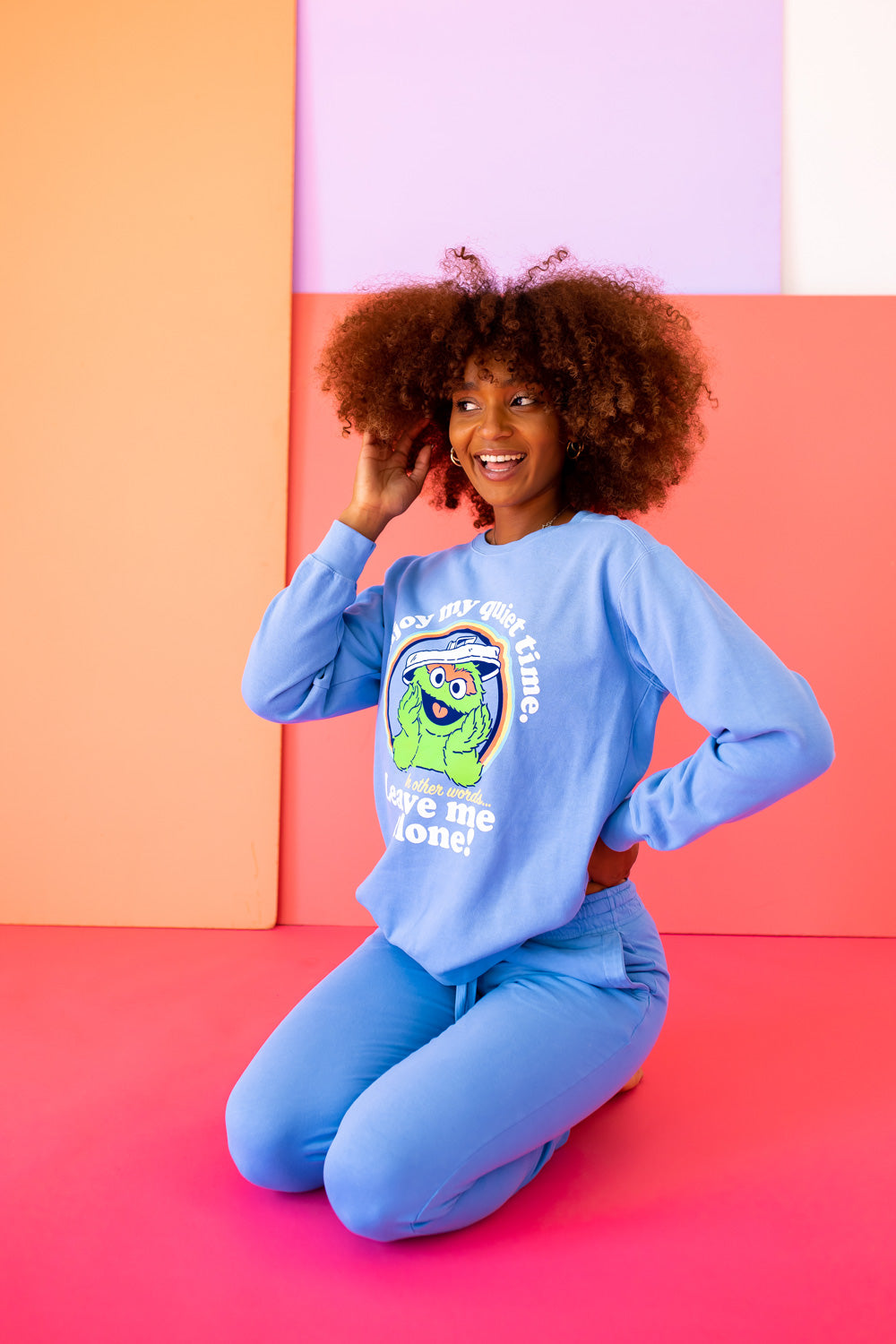 A vibrant blue sweatshirt featuring Oscar The Grouch, showcasing a playful design perfect for casual wear.