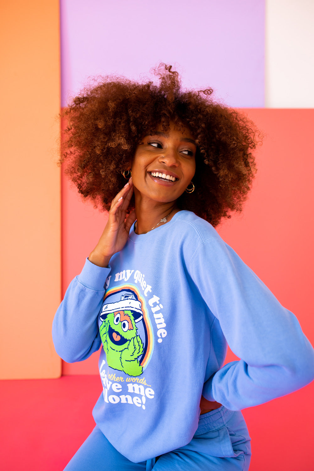 A vibrant blue sweatshirt featuring Oscar The Grouch, showcasing a playful design perfect for casual wear.