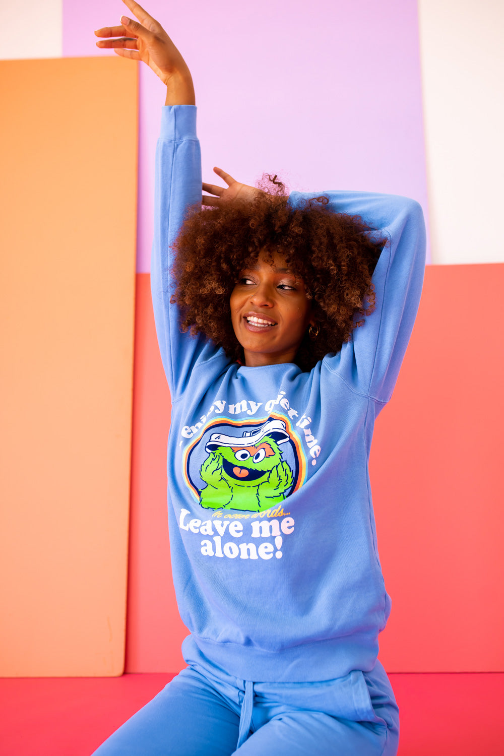 A vibrant blue sweatshirt featuring Oscar The Grouch, showcasing a playful design perfect for casual wear.