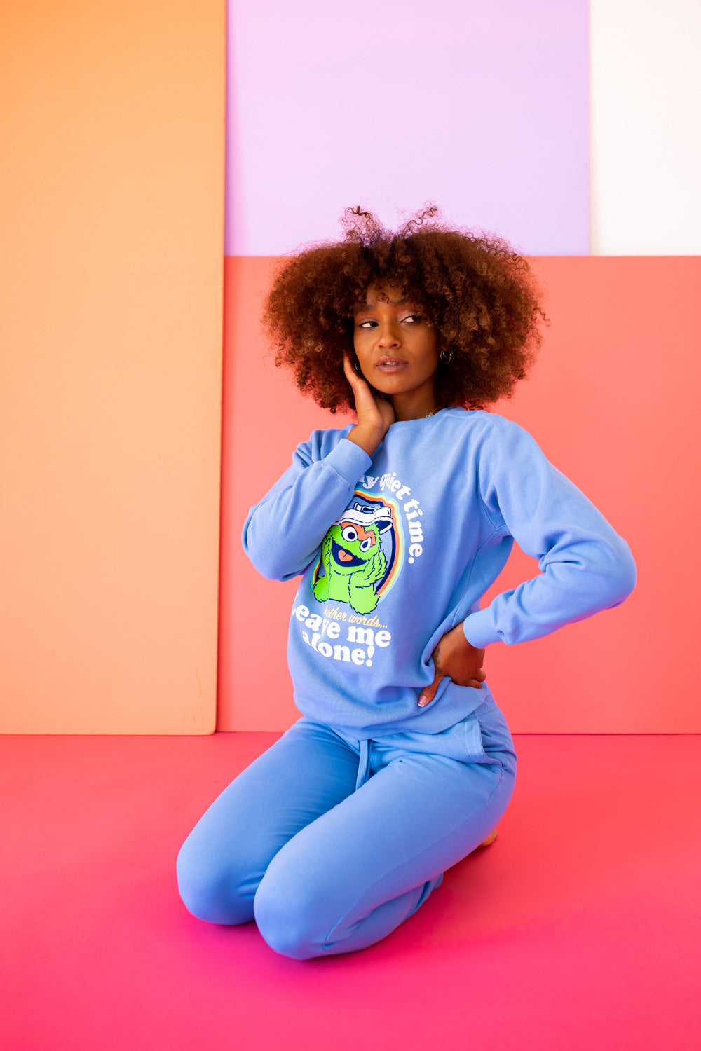 A vibrant blue sweatshirt featuring Oscar The Grouch, showcasing a playful design perfect for casual wear.
