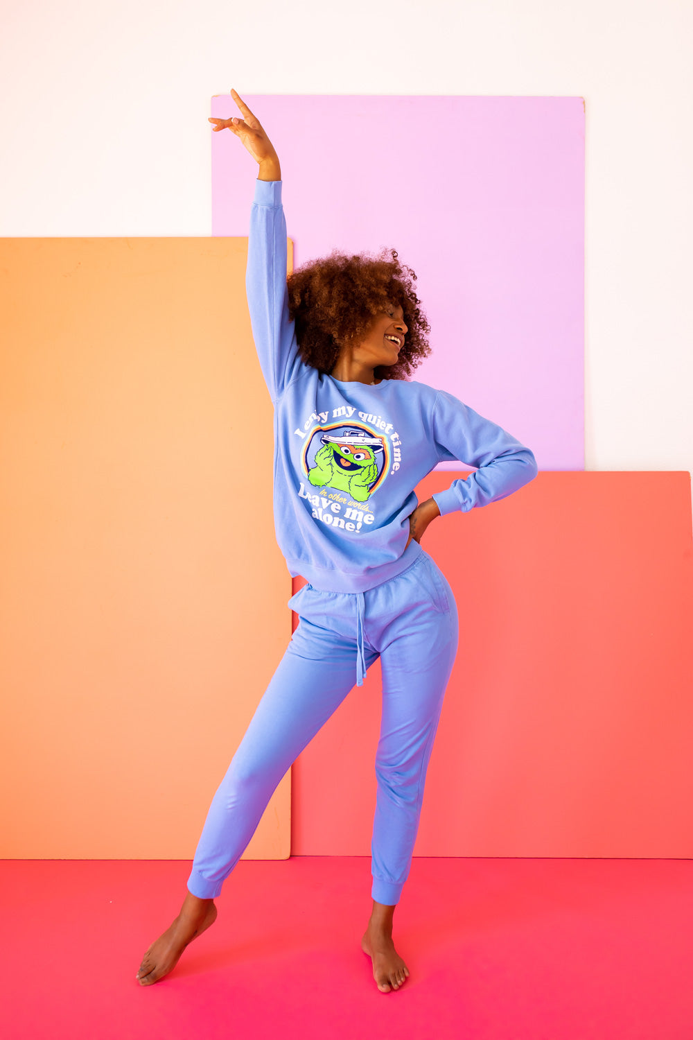 A vibrant blue sweatshirt featuring Oscar The Grouch, showcasing a playful design perfect for casual wear.