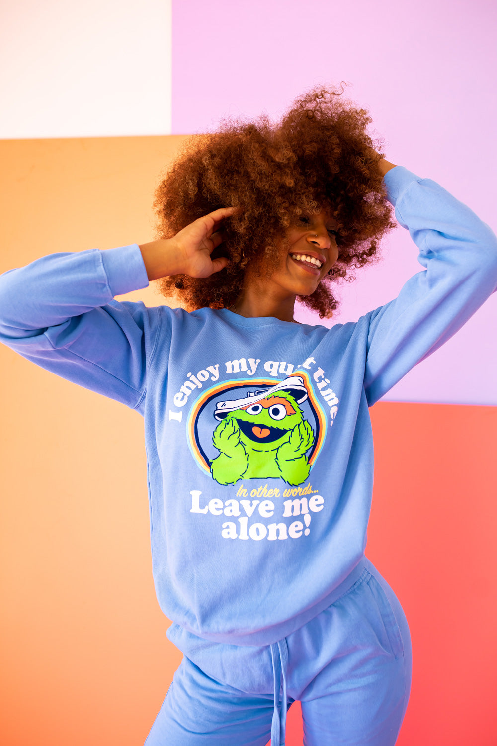 A vibrant blue sweatshirt featuring Oscar The Grouch, showcasing a playful design perfect for casual wear.