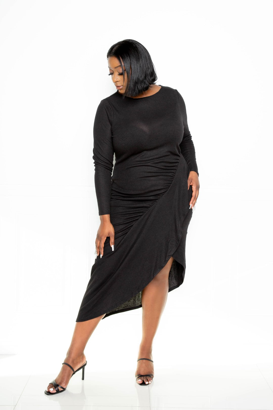 Asymmetrical sweater dress featuring a stylish waterfall ruffle in black, designed for plus sizes.