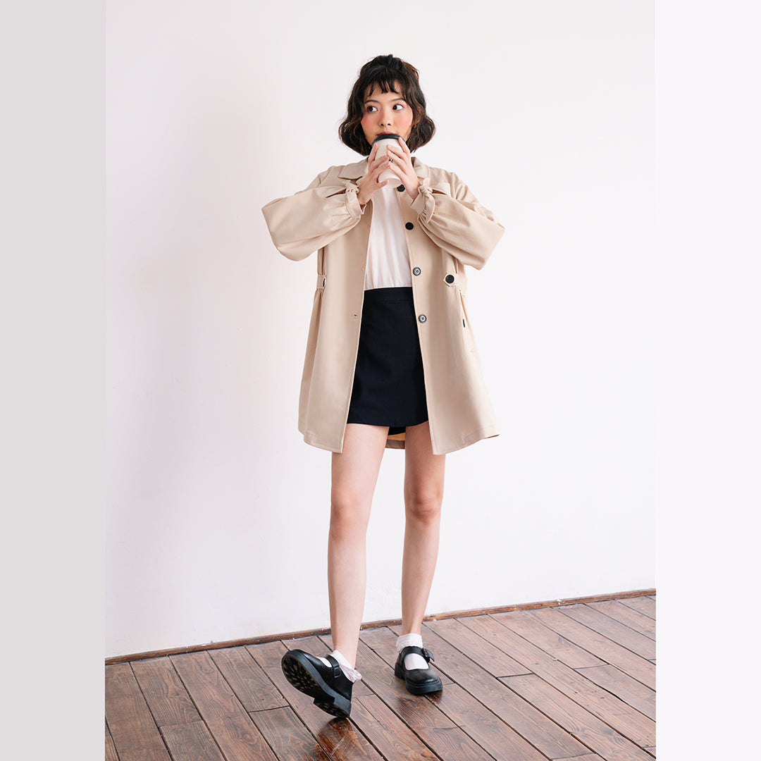 Aubrey Trenchcoat in soft khaki leather, showcasing its stylish design and wide form.