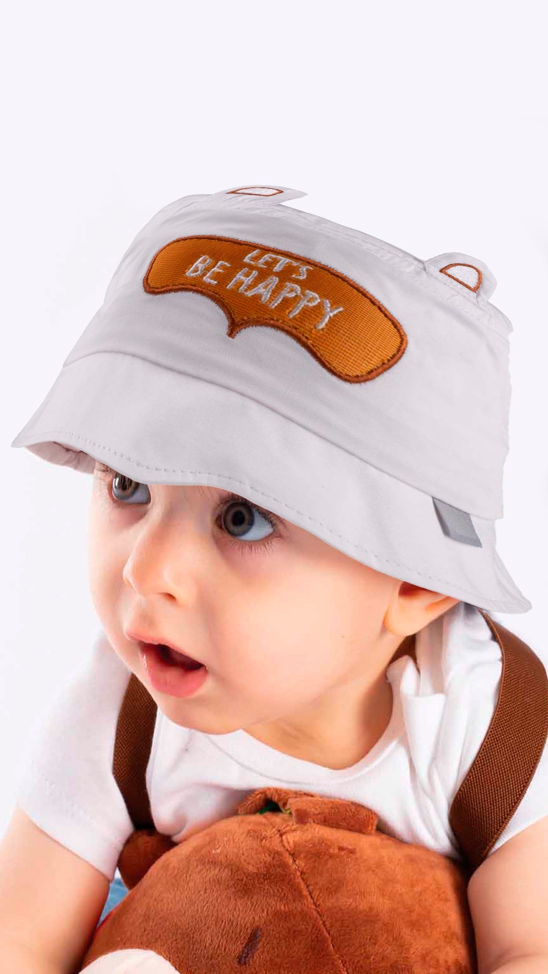 A stylish white baby bucket hat with 'Let's Be Happy' appliqué, perfect for toddlers aged 1-3 years, made from soft cotton blend.