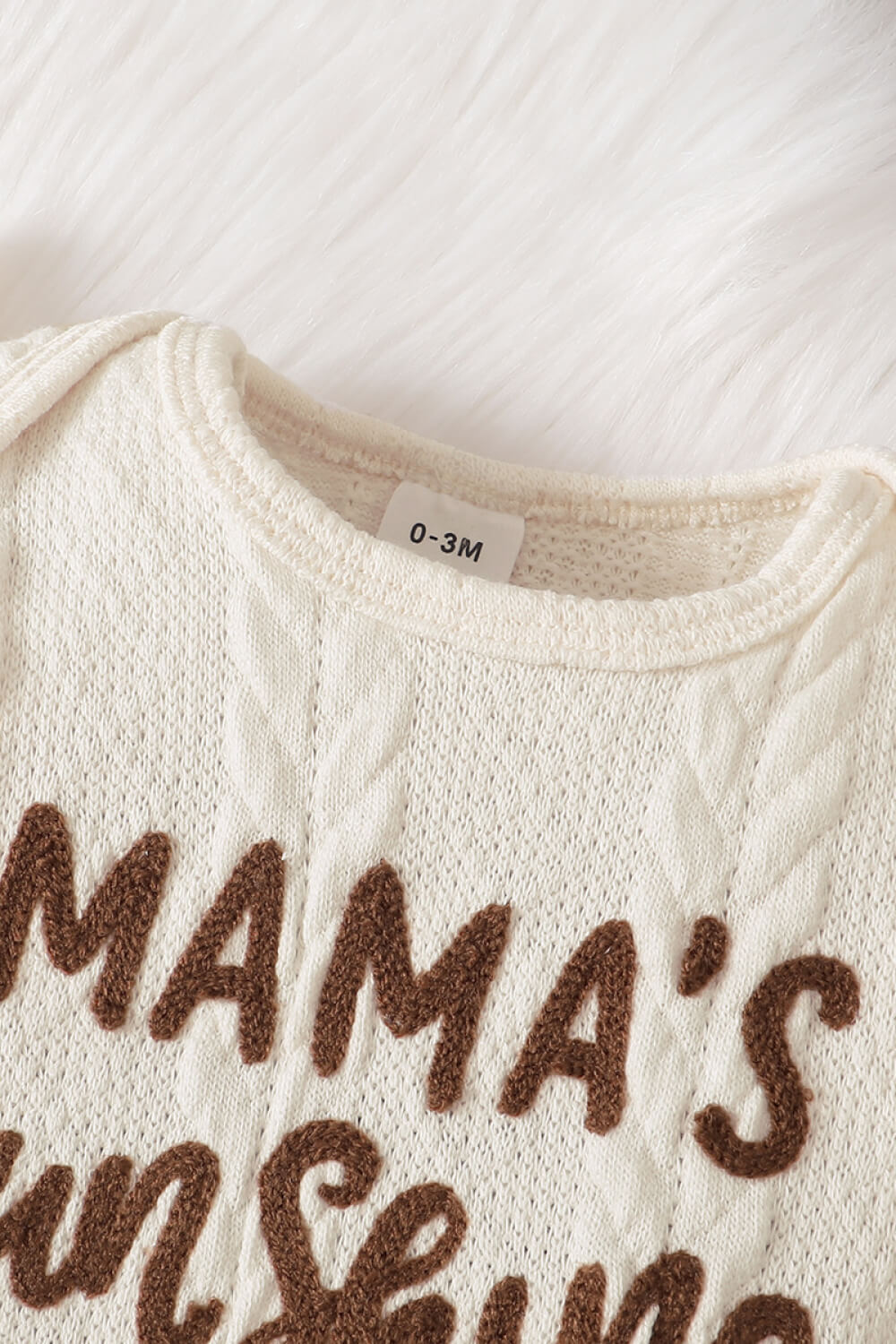 Baby girl wearing a letter graphic sweater and leopard print skirt, showcasing a stylish and comfortable outfit for infants.