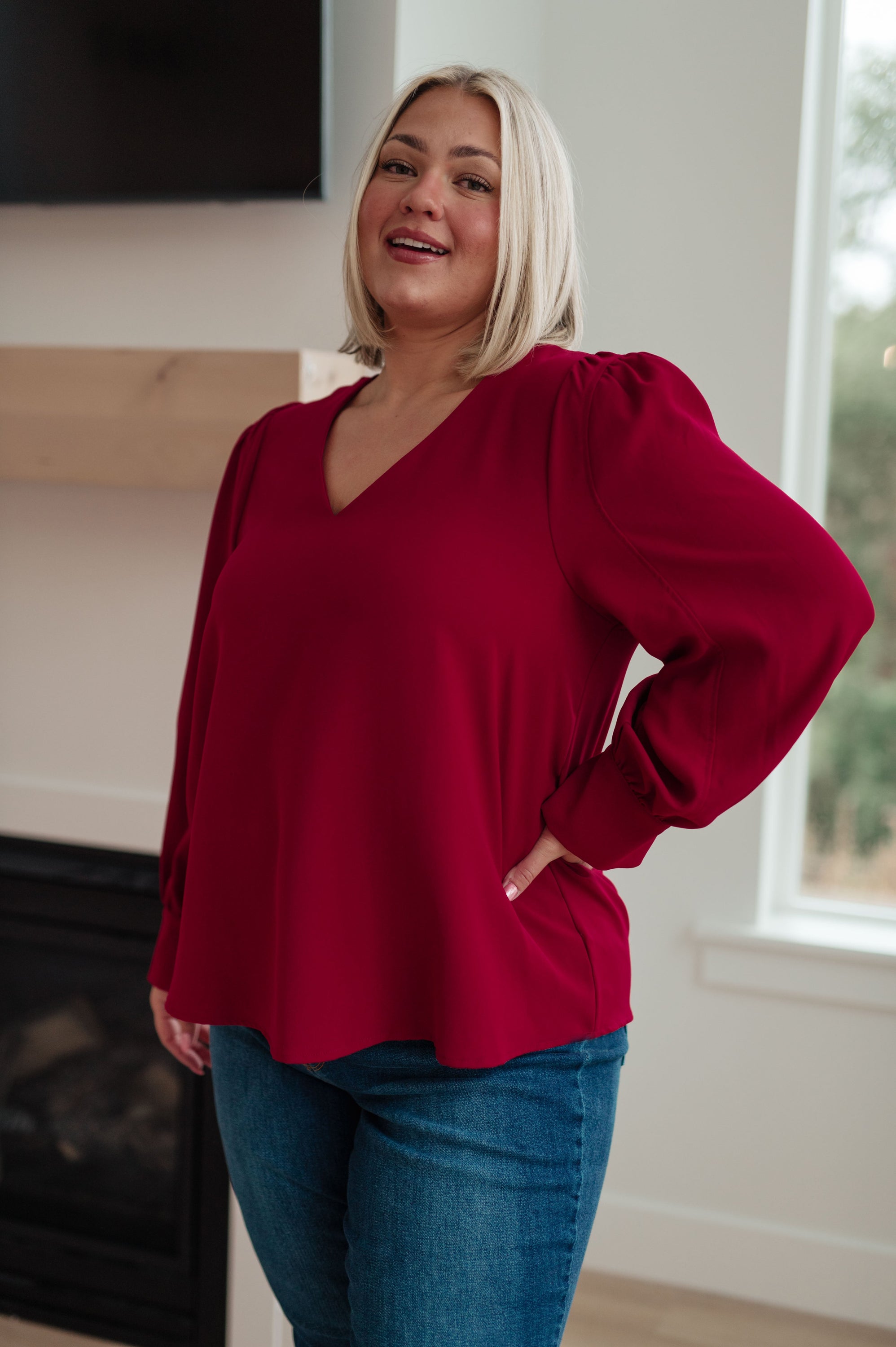 Back in Business V-Neck Blouse featuring puff sleeves and a flattering v-neckline in a deep color.
