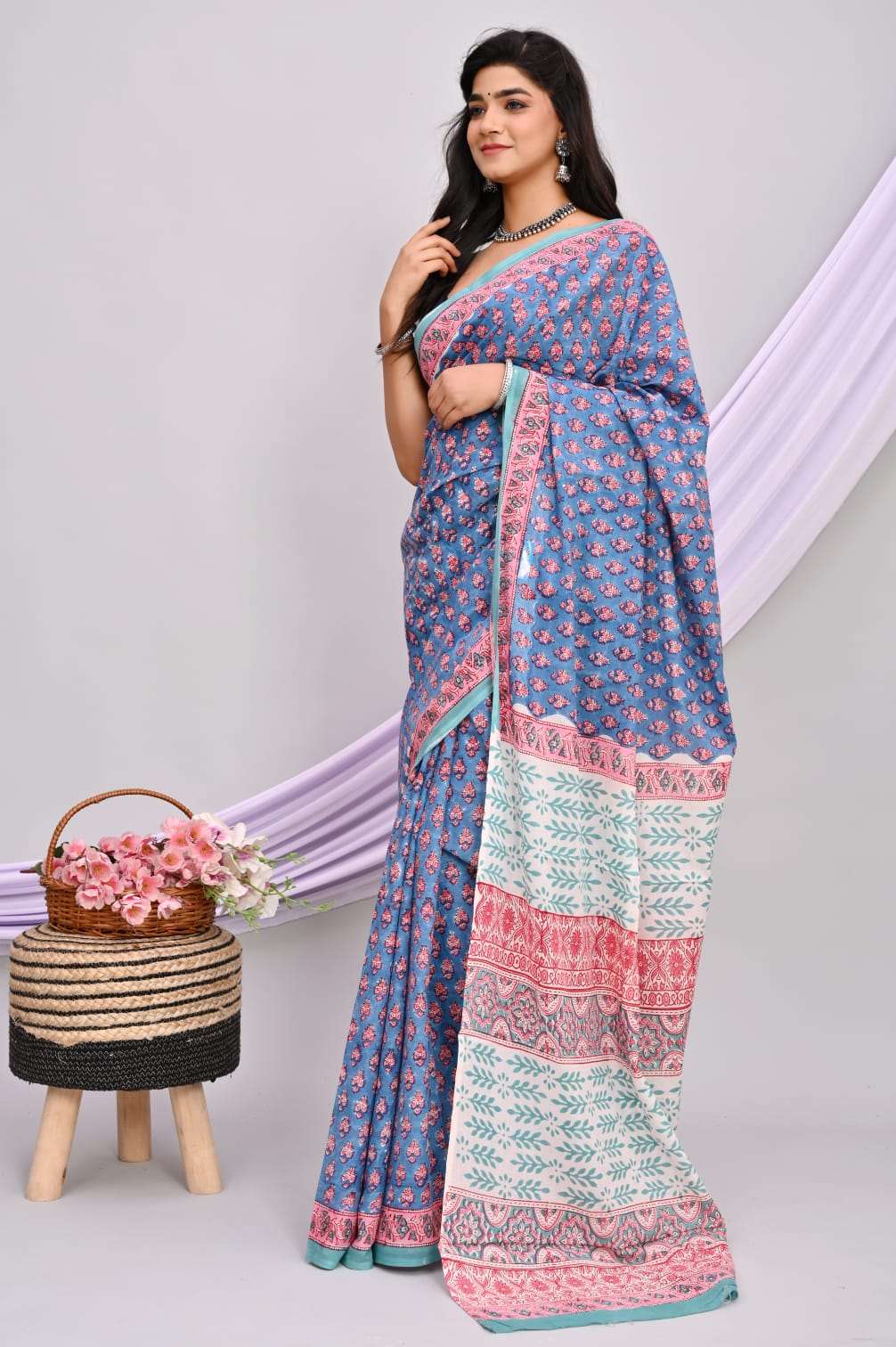 A beautiful Bagru hand block printed Kota Doria saree showcasing intricate patterns and vibrant colors, draped elegantly.