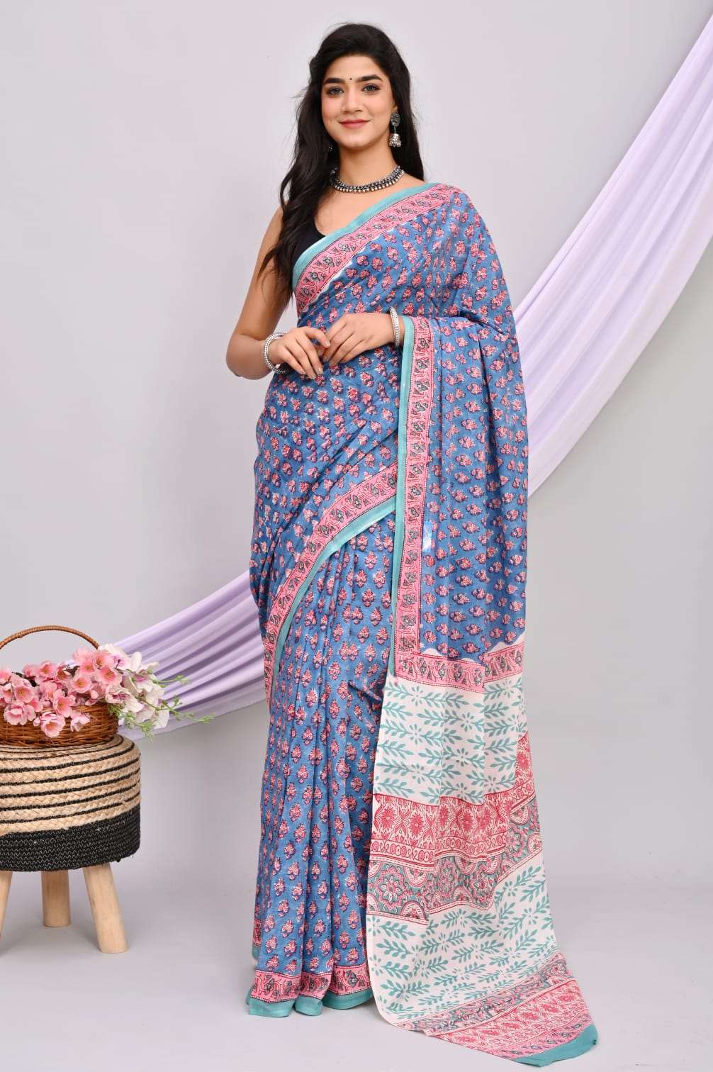 A beautiful Bagru hand block printed Kota Doria saree showcasing intricate patterns and vibrant colors, draped elegantly.