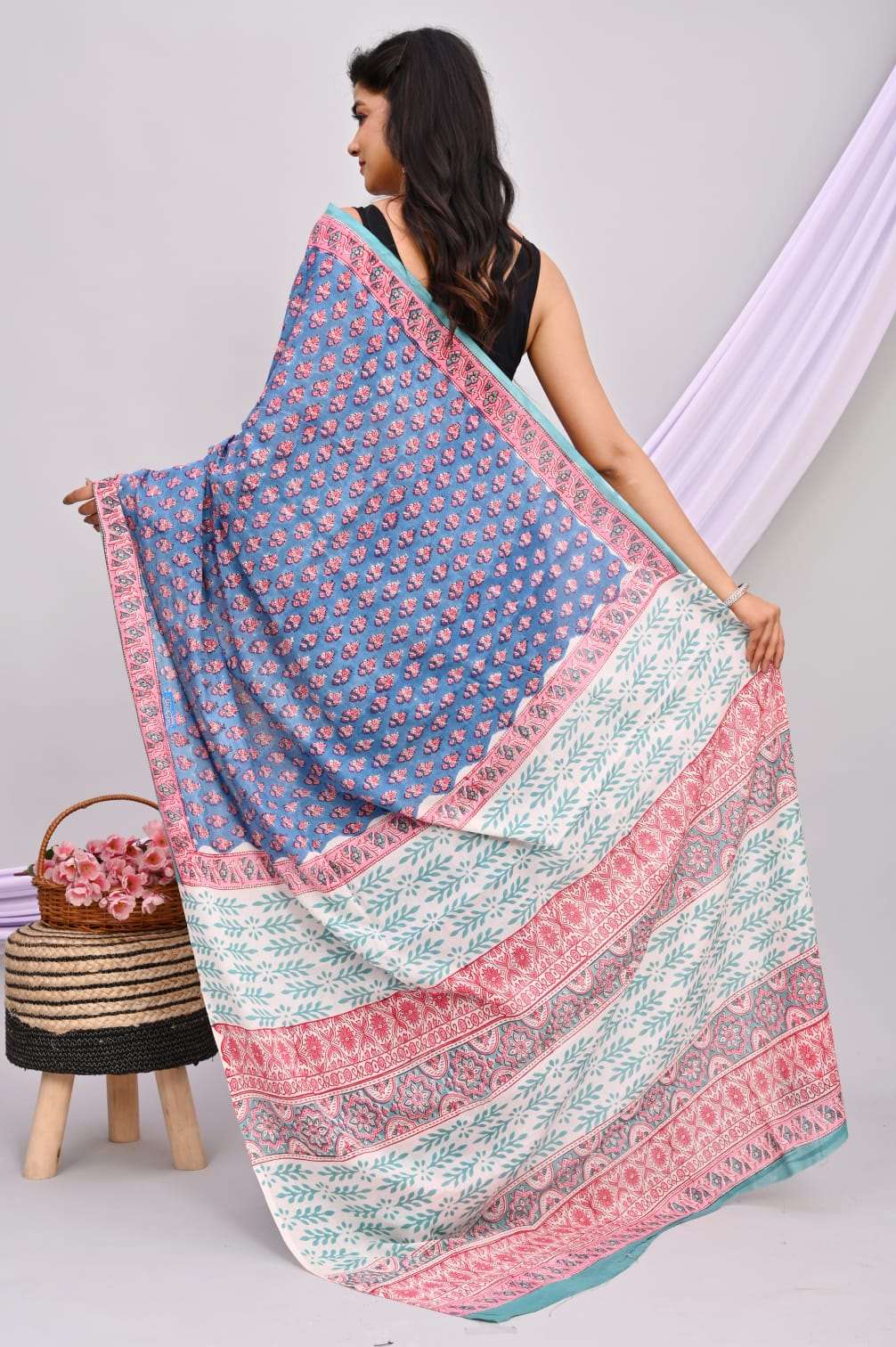 A beautiful Bagru hand block printed Kota Doria saree showcasing intricate patterns and vibrant colors, draped elegantly.