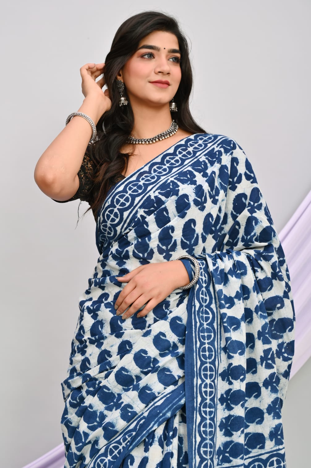 A beautiful Bagru hand block printed Kota Doria saree showcasing intricate patterns and vibrant colors, draped elegantly.