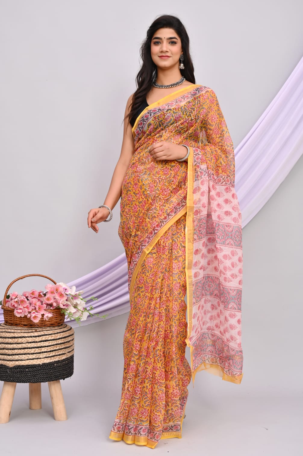 A beautiful Bagru hand block printed Kota Doria saree showcasing intricate patterns and vibrant colors, draped elegantly.