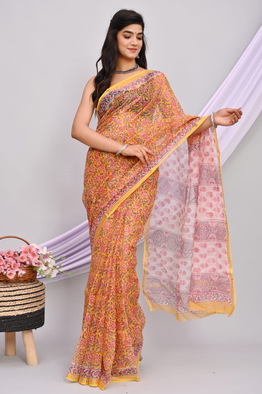 A beautiful Bagru hand block printed Kota Doria saree showcasing intricate patterns and vibrant colors, draped elegantly.