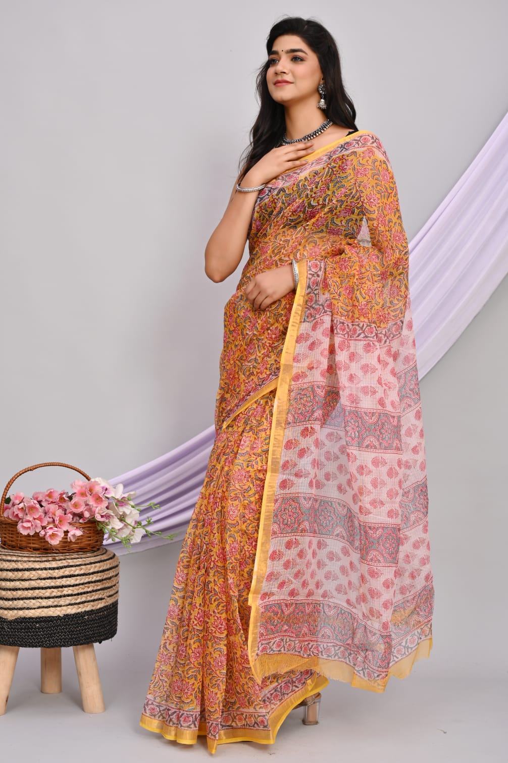 A beautiful Bagru hand block printed Kota Doria saree showcasing intricate patterns and vibrant colors, draped elegantly.