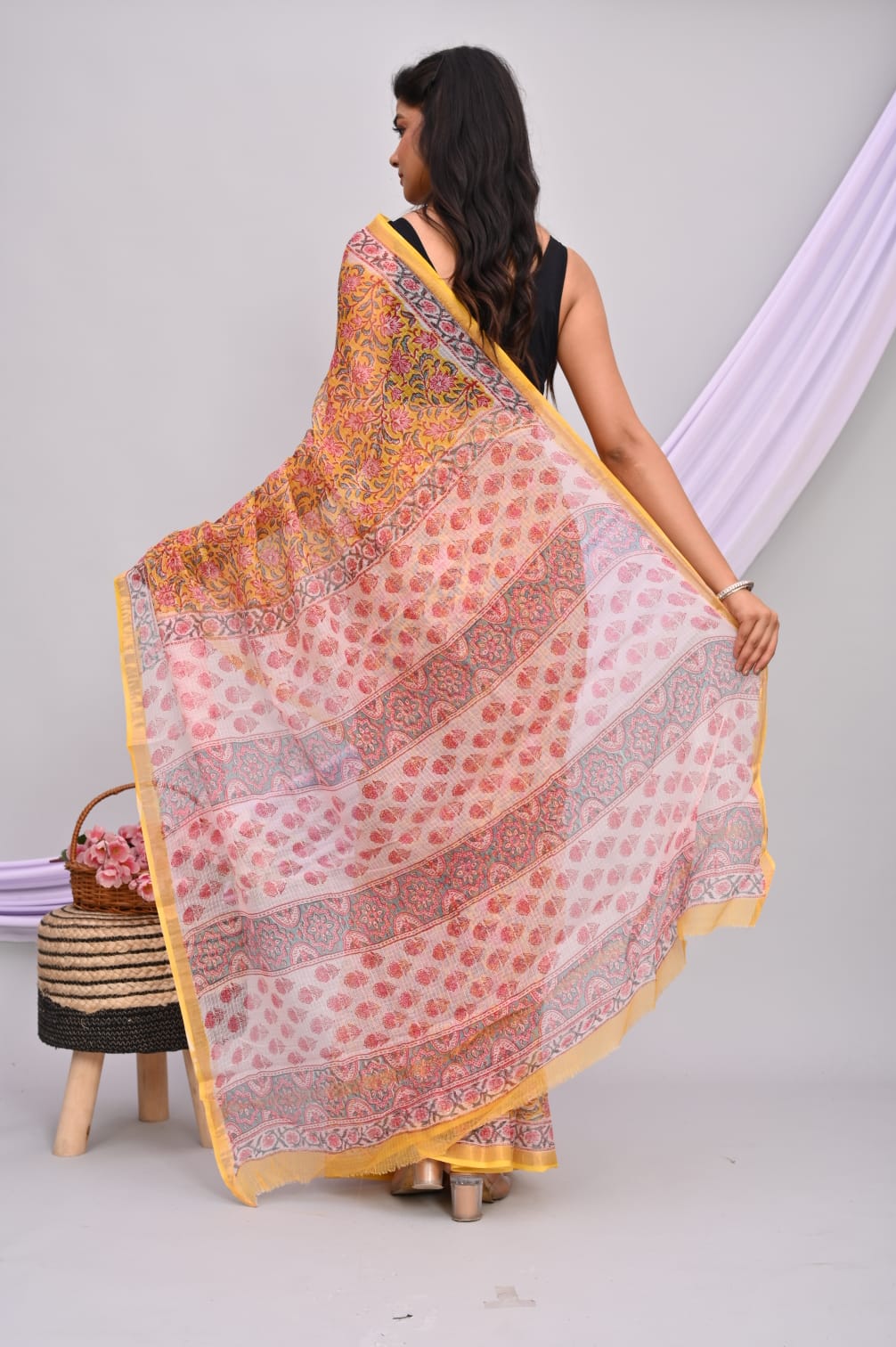 A beautiful Bagru hand block printed Kota Doria saree showcasing intricate patterns and vibrant colors, draped elegantly.