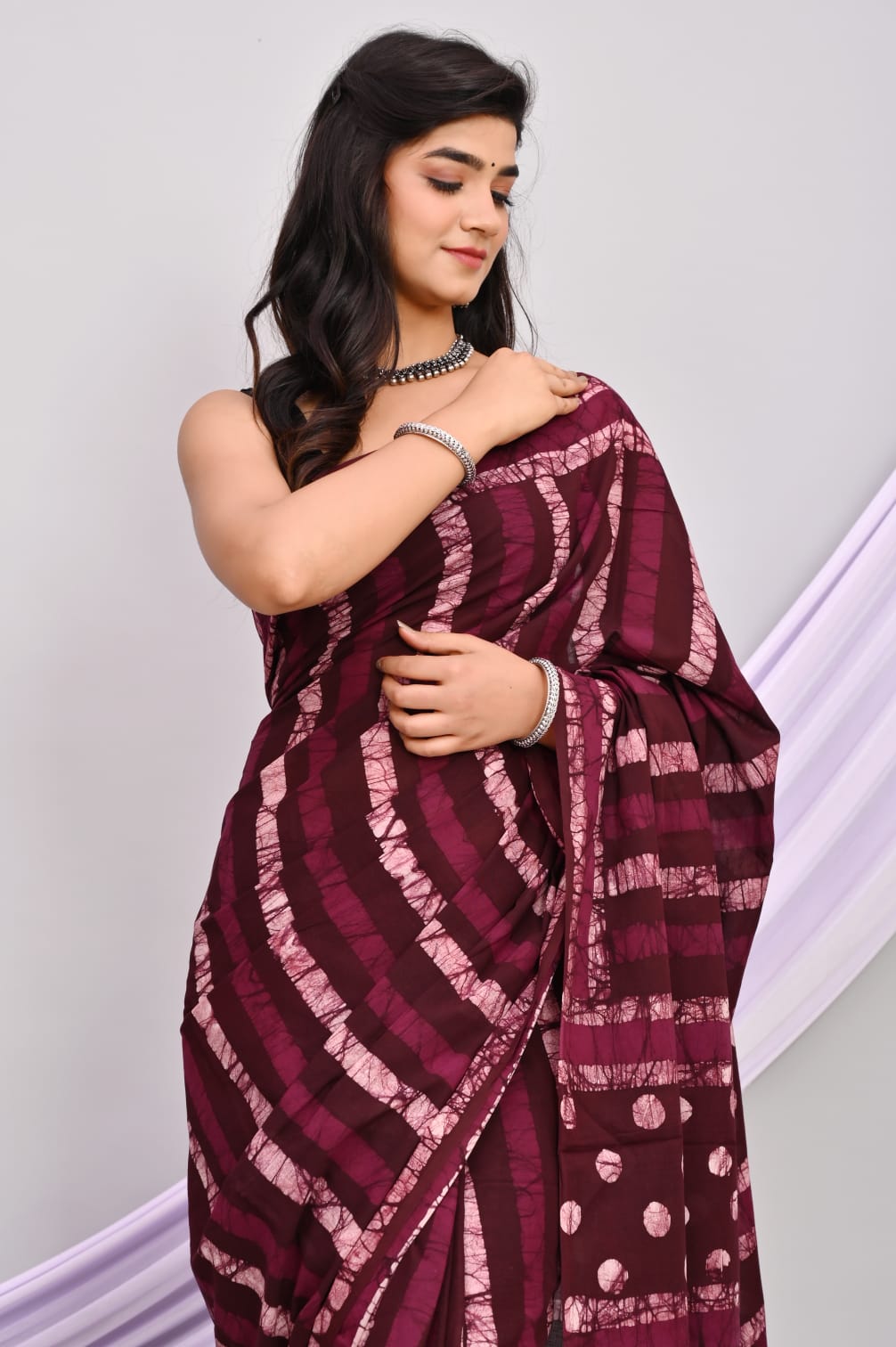A beautiful Bagru hand block printed Kota Doria saree showcasing intricate patterns and vibrant colors, draped elegantly.