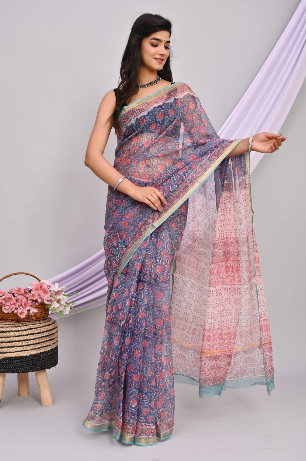 A beautiful Bagru hand block printed Kota Doria saree showcasing intricate patterns and vibrant colors, draped elegantly.