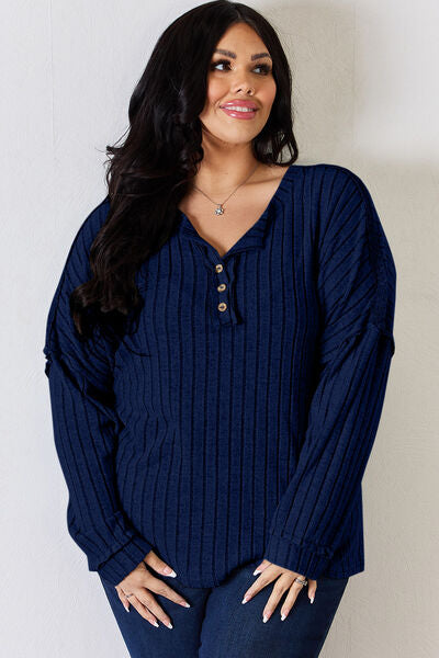 Basic Bae Full Size Ribbed Half Button Long Sleeve T-Shirt in a stylish ribbed design, showcasing its half-button feature and comfortable fit.