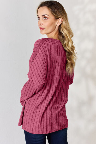 Basic Bae Full Size Ribbed Half Button Long Sleeve T-Shirt in a stylish ribbed design, showcasing its half-button feature and comfortable fit.
