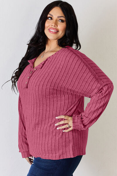 Basic Bae Full Size Ribbed Half Button Long Sleeve T-Shirt in a stylish ribbed design, showcasing its half-button feature and comfortable fit.
