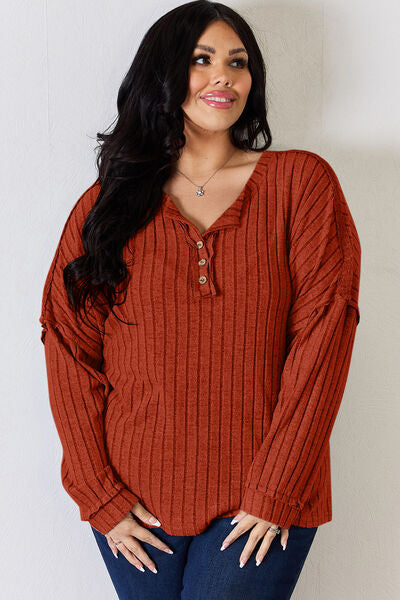 Basic Bae Full Size Ribbed Half Button Long Sleeve T-Shirt in a stylish ribbed design, showcasing its half-button feature and comfortable fit.