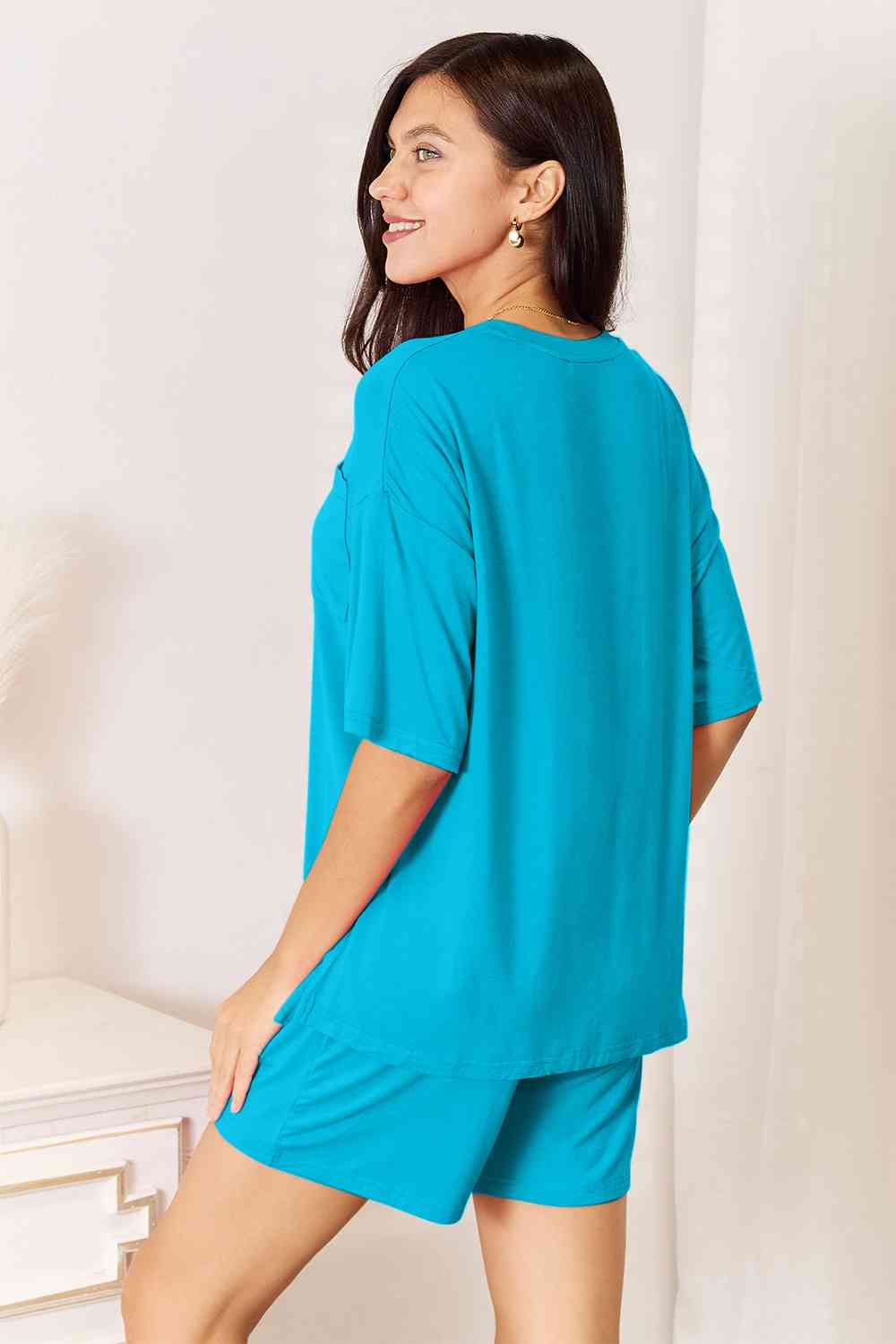 Basic Bae Full Size Soft Rayon Half Sleeve Top and Shorts Set displayed on a mannequin, showcasing its relaxed fit and stylish design.