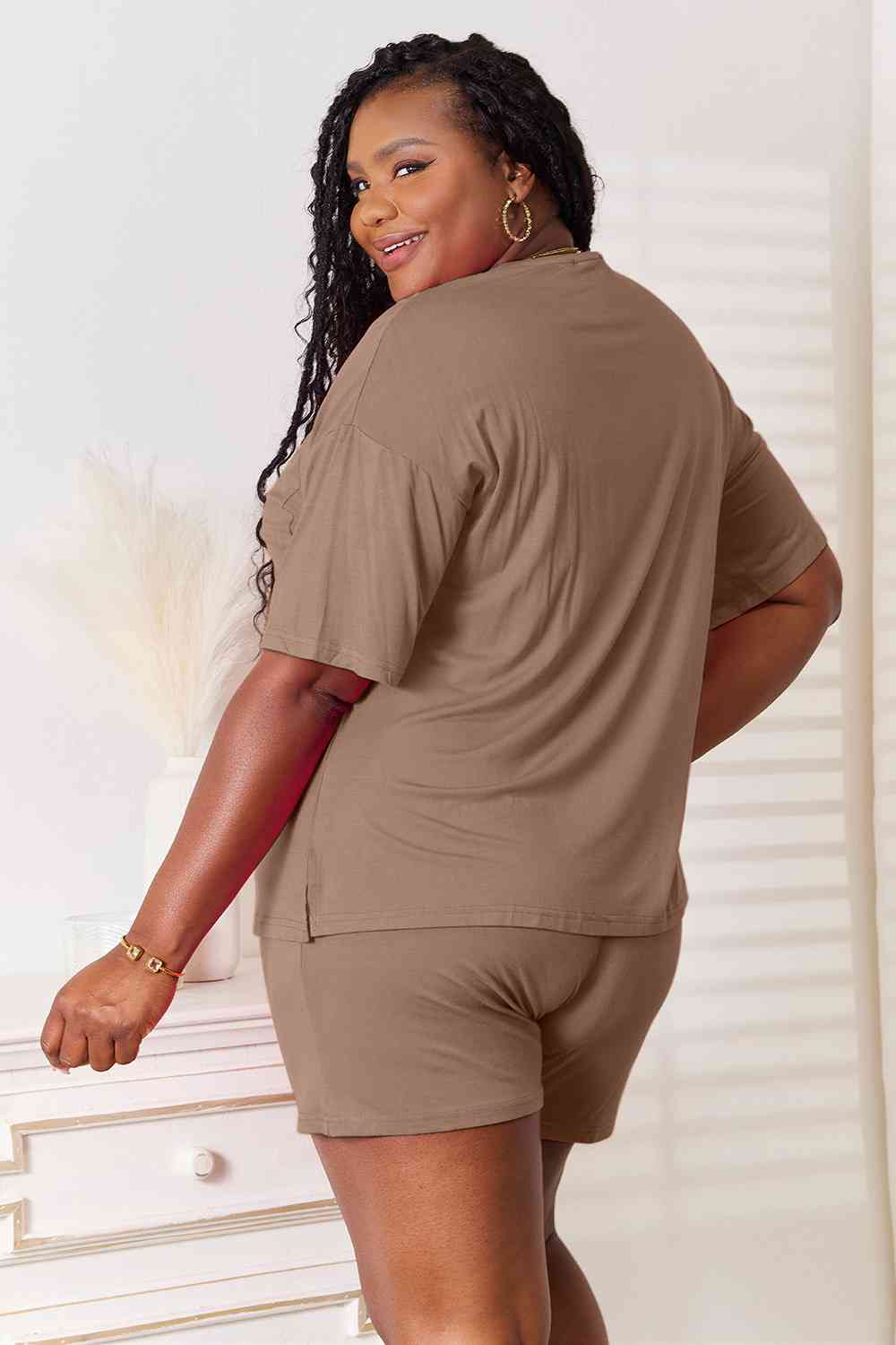 Basic Bae Full Size Soft Rayon Half Sleeve Top and Shorts Set displayed on a mannequin, showcasing its relaxed fit and stylish design.
