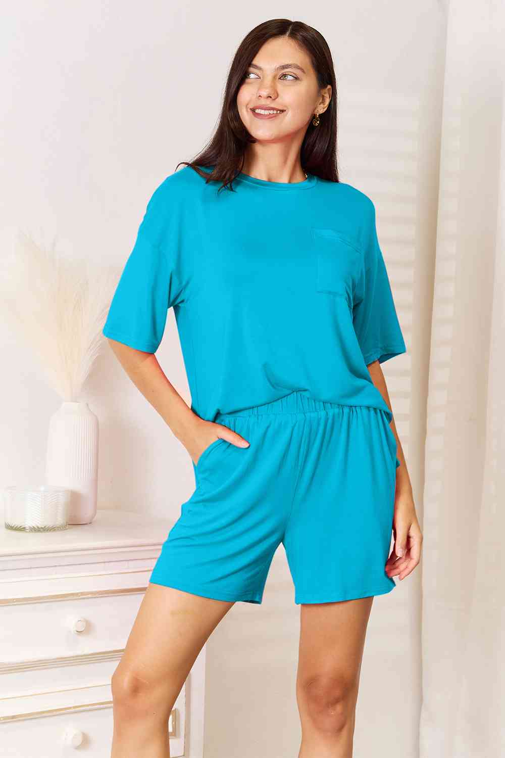 Basic Bae Full Size Soft Rayon Half Sleeve Top and Shorts Set displayed on a mannequin, showcasing its relaxed fit and stylish design.